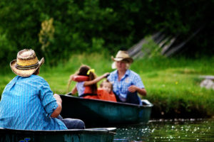 Family canoeing in the pond