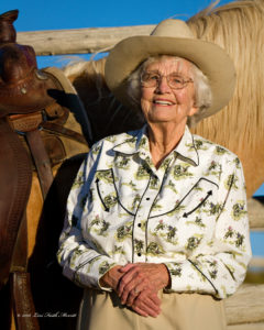 Woman smiling in front of a horse