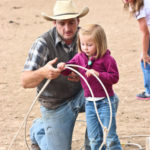 Little girl learning how to cowboy rope