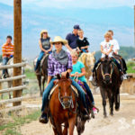 Cowgirl leading a horseback ride
