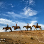 Riding horses in the mountains