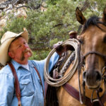 Man taking care of his horse